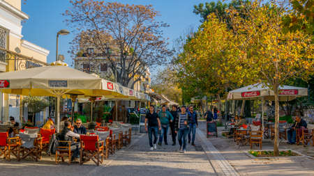 ATHENS, GREECE, DECEMBER 10, 2015: tourists are walking through a narrow alley between agora complex and many restaurantsのeditorial素材