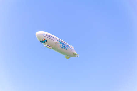 FRIEDRICHSHAFEN, GERMANY, JULY 24, 2016: a commercial airship is carrying passengers over bodensee near friedrichshafen, germany.のeditorial素材