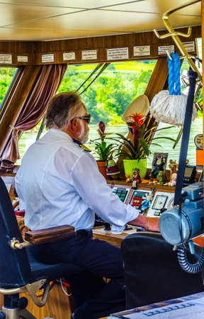 MELK, AUSTRIA, MAY 16, 2015: Captian is driving a river boat full of tourist on a romantic cruise through wachau valley in Austriaのeditorial素材