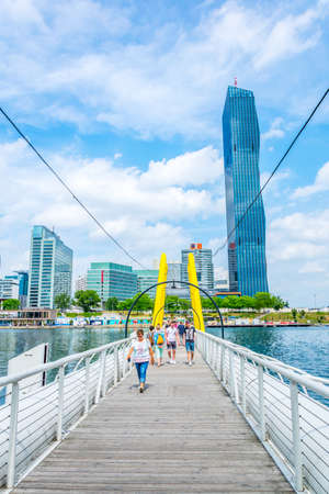 VIENNA, AUSTRIA, JUNE 2016. View of a floating bridge over danube river near VIC and Donauturm in Vienna, Austria.のeditorial素材