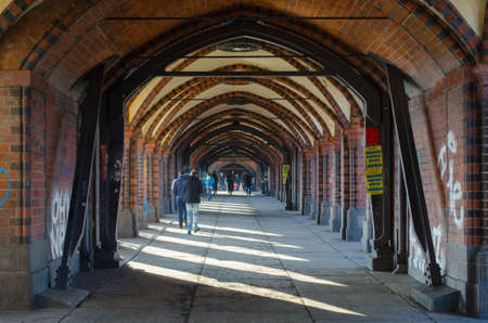 BERLIN, GERMANY, MARCH 12, 2015: brick arcs of oberbaumbrucke creates covered passage for pedestrians in berlin.のeditorial素材