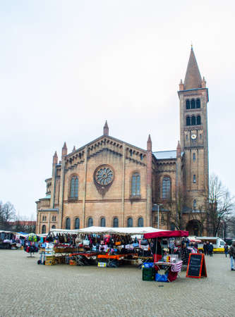 POTSDAM, GERMANY, MARCH 11, 2015: open market is taking place in front of the saint peter and paul church in potsdam, germany.のeditorial素材
