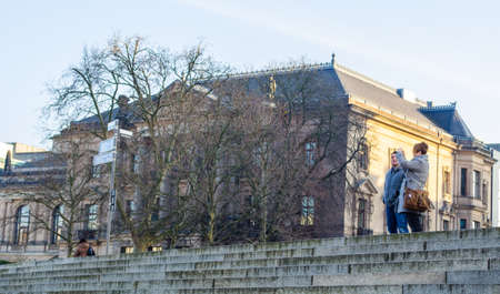 BERLIN, GERMANY, MARCH 12, 2015: people are taking pictures of spree river from behind of the reichstag building in berlin.のeditorial素材