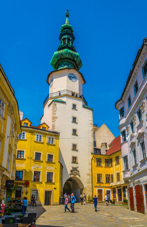 BRATISLAVA, SLOVAKIA, MAY 28, 2016: people are walking through michalska street dominated by white michalska tower in historical center of Bratislava, Slovakiaのeditorial素材