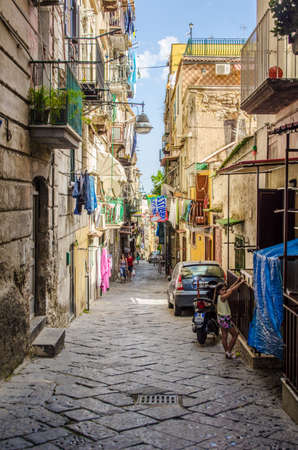 NAPLES, ITALY, JUNE 24, 2014: People are passing by through narrow streets of historical old town in italian naples.のeditorial素材