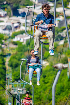 CAPRI, ITALY, MAY 15, 2014: group of tourist is ascending hill on chairlift situated on capri island in italy.のeditorial素材