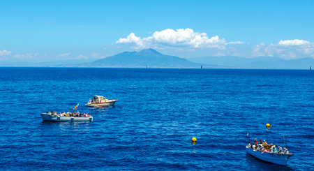 CAPRI, ITALY, MAY 15, 2014: peoplea re waiting on various boats in order to get into the famous...