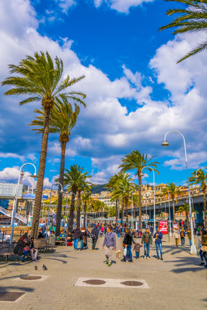GENOA, ITALY, MARCH 13, 2016: people are strolling over seaside promenade leading through port of genoa. The port offers various attractions for tourists like the european biggest aquarium.のeditorial素材