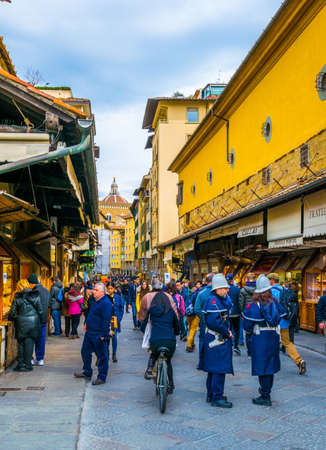 FLORENCE, ITALY, MARCH 15, 2016: People are strolling among expansive shops situated on the ponte vecchio bridge in the italian city florenceのeditorial素材