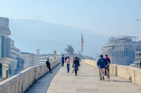 SKOPJE, MACEDONIA, FEBRUARY 16, 2015: people are crossing famous stone bridge in macedonian capital skopje, fyrom.のeditorial素材