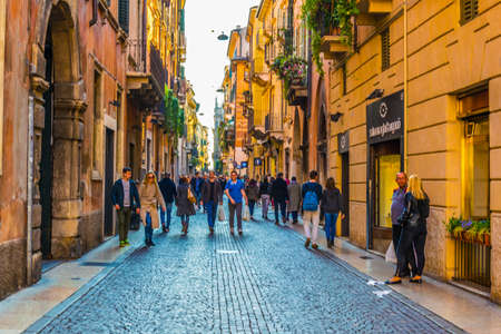 VERONA, ITALY, MARCH 19, 2016: people are strolling through a narrow street towards Dominican church of Santa Anastasia in Verona, Italyのeditorial素材