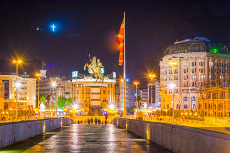 SKOPJE, MACEDONIA, MAY 14, 2016: Night view of the ancient stone bridge in the macedonian capital skopje leading to the macedonia square dominated by statue of alexander the great.のeditorial素材