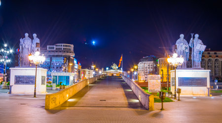 SKOPJE, MACEDONIA, MAY 14, 2016: Night view of the ancient stone bridge in the macedonian capital skopje leading to the macedonia square dominated by statue of alexander the great.のeditorial素材