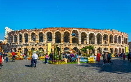 VERONA, ITALY, MARCH 19, 2016: People are strolling among flower stands during Saturday market on the piazza bra in front of the roman arena in the Italian city Veronaのeditorial素材