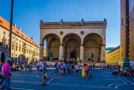 MUNICH, GERMANY, AUGUST 20, 2015: Odeonsplatz at sunset in Munich, Germany. Odeonsplatz is surrounded by sightseeing spots Theatinekirche, Feldherrnhalle, Residenz Munchen and Hofgarten.のeditorial素材