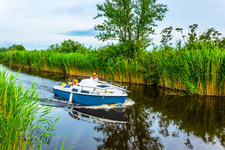 EISENSTADT, AUSTRIA, JUNE 18, 2016: View of a boat on a water channel leading to the neusiedlersee in Austriaのeditorial素材