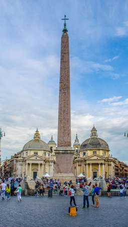 ROME, ITALY, MAY 30, 2014: People are passing by central column on square piazza del popolo in romeのeditorial素材