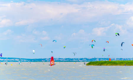 PODERSDORF, AUSTRIA, JULY 9, 2016: Young people are kite surfing on the neusiedlersee lake in Austria near Podersdorf am See town.のeditorial素材