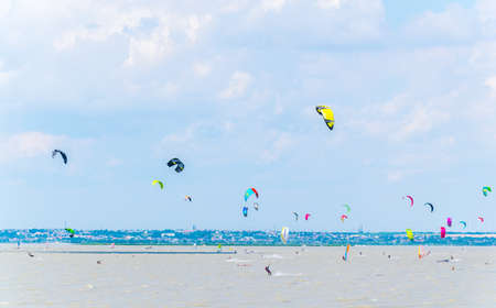 PODERSDORF, AUSTRIA, JULY 9, 2016: Young people are kite surfing on the neusiedlersee lake in...