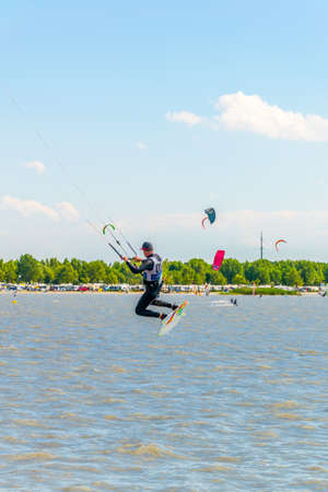 PODERSDORF, AUSTRIA, JULY 9, 2016: Young people are kite surfing on the neusiedlersee lake in Austria near Podersdorf am See town.のeditorial素材