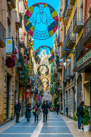 TARRAGONA, SPAIN, DECEMBER 29, 2015: people are walking through the main shopping street in the historical center of spanish city tarragona - carrer majorのeditorial素材
