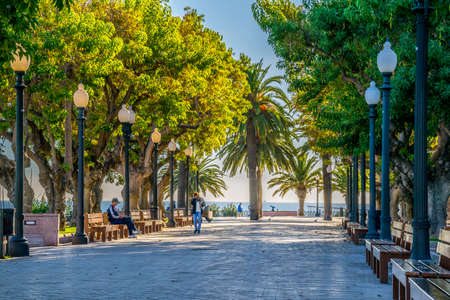 TARRAGONA, SPAIN, DECEMBER 29, 2015: people are relaxing on the promenade on a seaside in the spanish city Tarragonaのeditorial素材