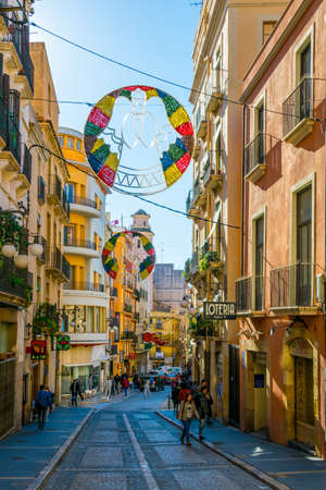 TARRAGONA, SPAIN, DECEMBER 29, 2015: people are strolling through a colorful narrow street in the historical center of spanish city tarragonaのeditorial素材