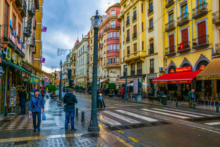 GRANADA, SPAIN, JANUARY 3, 2016: people are strolling through center of the old town of granada dutring cloudy and rainy dayのeditorial素材