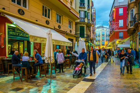 MALAGA, SPAIN, JANUARY 4, 2016: crowds of tourists are strolling through the historical center of malaga after sunsetのeditorial素材