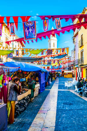 XATIVA, SPAIN, JANUARY 2, 2016: merchant are trying to sell their products during traditional marketplace on a square in the spanish city xativaのeditorial素材