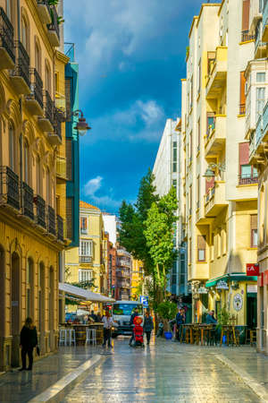 MALAGA, SPAIN, JANUARY 4, 2016: View of a narrow street in the historical center of Malaga where crowds of tourists are seeking for shops, restaurants or bars.のeditorial素材
