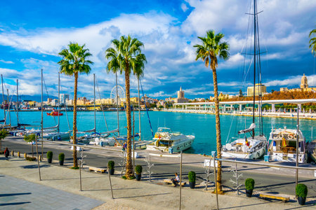 MALAGA, SPAIN, JANUARY 4, 2016: people are walking on a promenade surrounded by marina in the port of malaga in spain.のeditorial素材