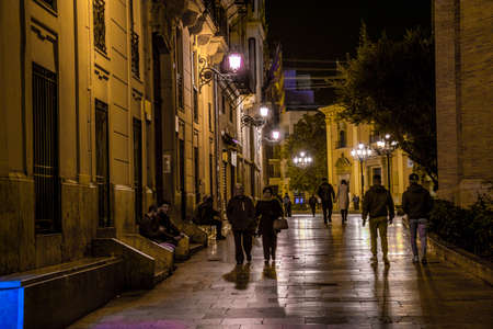 VALENCIA, SPAIN, DECEMBER 31, 2015: people are walking through a narrow street in the old town center of spanish city valencia.のeditorial素材