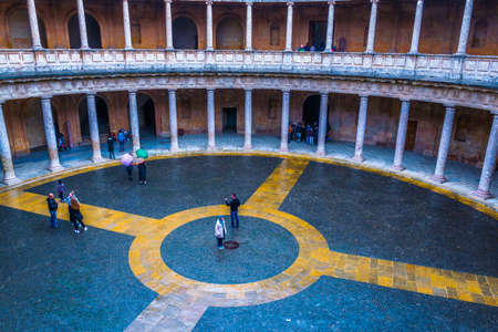 GRANADA, SPAIN, JANUARY 3, 2016: People are walking over a courtyard at the Palace of Charles V (Palacio de Carlos V) in Alhambra in Granada, Spain.のeditorial素材