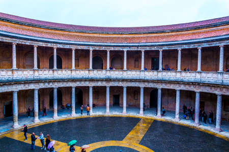 GRANADA, SPAIN, JANUARY 3, 2016: People are walking over a courtyard at the Palace of Charles V (Palacio de Carlos V) in Alhambra in Granada, Spain.のeditorial素材
