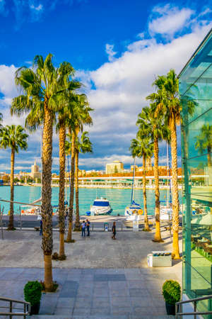 MALAGA, SPAIN, JANUARY 4, 2016: people are walking on a promenade surrounded by marina in the port of malaga in spain.のeditorial素材