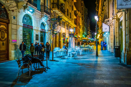 ALICANTE, SPAIN, JANUARY 2, 2016: View of a narrow street in the historical center of spanish city alicante where local people enjoy nightlife in front of many bars.のeditorial素材