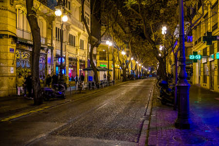 VALENCIA, SPAIN, DECEMBER 31, 2015: people are walking through a narrow street in the old town center of spanish city valencia.のeditorial素材
