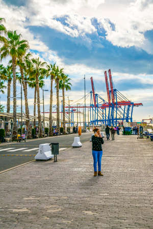 MALAGA, SPAIN, JANUARY 4, 2016: people are walking on a promenade surrounded by marina in the port of malaga in spain.のeditorial素材