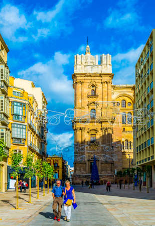 MALAGA, SPAIN, JANUARY 4, 2016: View of a narrow street in the historical center of Malaga where crowds of tourists are seeking for shops, restaurants or bars.のeditorial素材