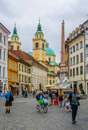 LJUBLJANA, SLOVENIA, JULY 29, 2015: town hall in the slovenian capital ljubljana dominates the mestni trg square, which is decorated by robb fountain and view of the twin tower of the local cathedral.のeditorial素材