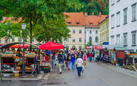 LJUBLJANA, SLOVENIA, JULY 29, 2015: People are strolling among stands in the central market of the slovenian capital Ljubljana and buy various products often from local farmers.のeditorial素材