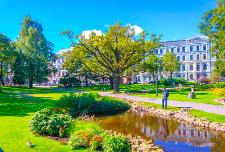 RIGA, LATVIA, AUGUST 15, 2016: People are walking through the Bastelkajna park in Riga, Latvia.のeditorial素材