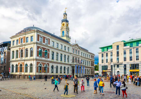 RIGA, LATVIA, AUGUST 15, 2016: People are walking in front of the town hall of the Latvian capital Riga, Latvia.のeditorial素材