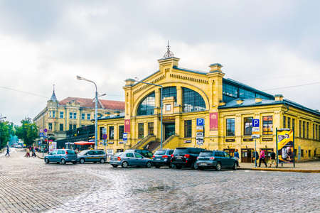 VILNIUS, LITHUANIA, AUGUST 14, 2016: People are doing shopping in a covered marketplace in Vilnius,...