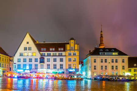 TALLIN, ESTONIA, AUGUST 16, 2016: Night view of restaurants surrounding the town hall square in the old town of Tallin, Estonia.のeditorial素材