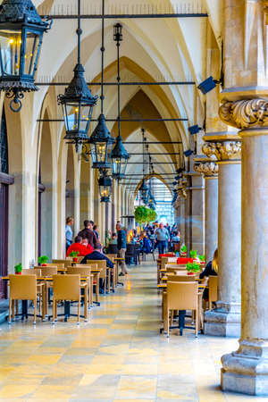 KRAKOW, POLAND, AUGUST 11, 2016: People are having lunch under arches of sukiennice marketplace in the polish city Cracow / Krakow.のeditorial素材