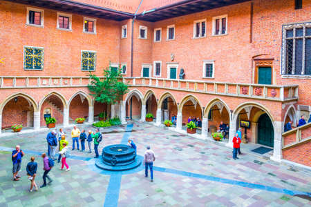 KRAKOW, POLAND, AUGUST 11, 2016: People are passing through the main courtyard of the Jagiellonian university in Cracow / Krakow, Poland.のeditorial素材