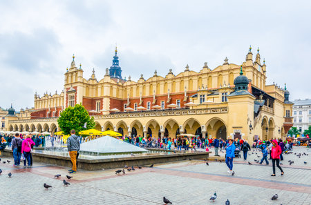 KRAKOW, POLAND, AUGUST 11, 2016: People are strolling in front of the Sukiennice marketplace (Cloth Hall, Drapers' Hall) in Krakow (Cracow), Polandのeditorial素材