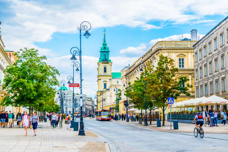 WARSAW, POLAND, AUGUST 12, 2016: People are strolling through the nowy swiat street in front of the Church of the Holy Cross, Warsaw, Polandのeditorial素材